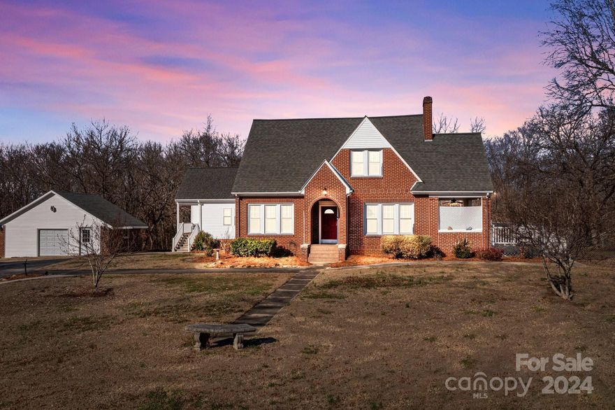 You will not want to miss this private 1930's brick home with 3 acres. Convenient to shopping and many restaurants. A warm and welcoming home with beautiful hardwood floors, updated kitchen with granite counter tops, cozy fireplace in living room, formal dining, 4 bedrooms, 2.5 baths, 2 storage buildings with electric plus a detached garage with electric and work bench. Home Warranty with Old Republic Home Warranty to cover buyer for one full year.  Well maintained home with many updates and partially finished basement. This is a must see!!