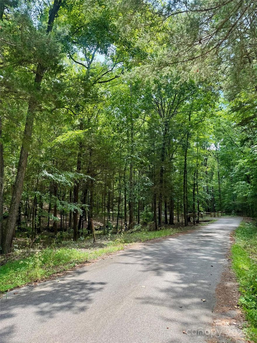 Discover this stunning 2.05-acre wooded lot offering privacy, beauty, and endless potential. Tucked away in a peaceful setting, this property features a serene landscape with a gentle stream, mature hardwood canopy, and natural building pads that make it perfect for your dream home—or multiple homes. No HOA, no minimum restrictions—giving you the freedom to build and live your way. Despite its tranquil feel, this property is in a highly desirable location with easy access to everything you need. A rare find that blends nature, privacy, and possibility.