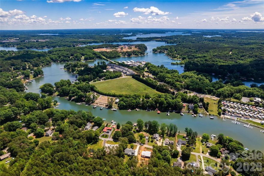 Own a piece of Lake Norman’s fastest-growing community! Rare and exceptional opportunity to own nearly 14 acres of prime, versatile property in the heart of Sherrills Ford, one of the fastest-growing areas at Lake Norman. Offering expansive water views surrounded by Lake Norman, this property is truly unique and rarely found.  This property is perfect for building your dream home or dividing into individual lots.  Maximum density approved units: 1.5 units per acre per Catawba County.  One minute away, you will find Lake Norman Marina, where you can get your boat rentals.  Three minutes away, you will find another marina, Midway, that also offers paddleboard and kayak rentals.  Enjoy the best of both lake and land here!  Located in a high-demand area with excellent access to I-77, Highway 150, Highway 16, and Highway 321.  Water comes in on Vinewood for neighboring townhomes.    There is a well and drainfield easement on the back of the property (see survey). No manufactured homes allowed. Listing agent related to sellers.