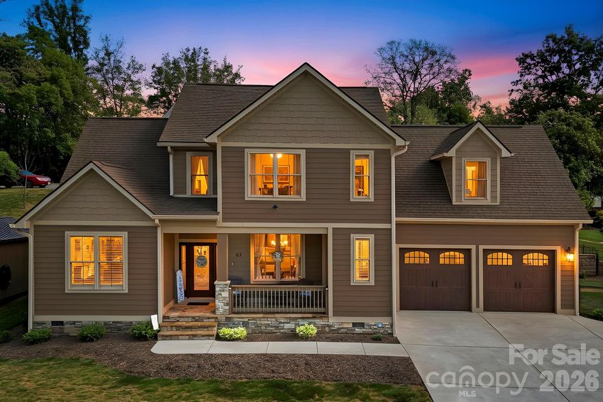 Welcome to 63 Old Spring Drive — a thoughtfully designed newer construction home tucked away on over half an acre in desirable Candler, where privacy, comfort, and everyday functionality come together.

Built in 2020 and offering 2,130 square feet, this home invites you in with a warm, open-concept main level filled with natural light and vaulted ceilings that create an airy, spacious feel. The living room serves as the heart of the home, anchored by a gas fireplace with stunning stonework — a true focal point that adds both character and coziness.

Flowing seamlessly from the living space is a dedicated dining area and a beautifully appointed kitchen featuring an oversized granite island, stainless steel appliances, and plenty of room for gathering and entertaining. Just off the main living area, you’ll also find a convenient laundry room and half bath.

The primary suite is located on the main level, offering a private retreat complete with a spacious walk-in closet and an impressive en suite bath featuring dual vanities and a massive tiled walk-in shower with dual showerheads.

Upstairs, a loft overlooks the main living area, adding architectural interest and flexible space. Two additional bedrooms, a full bath, and a generous bonus room provide endless possibilities — whether you need a fourth bedroom, home office, or hobby space. A large walk-in attic offers exceptional storage.

Step outside and enjoy a lifestyle that’s just as inviting as the interior. The fenced yard provides space to relax, play, or entertain, while the screened-in porch and extended deck create the perfect setting for gatherings. While there are seasonal mountain views, mature trees enhance the sense of privacy and seclusion.

Additional highlights include an oversized 26x26 garage, expanded concrete driveway for extra parking, LP Smart Siding, insulated Pella windows, oak hardwood flooring, tile in kitchen and baths, tankless water heater, vapor barrier, heat pump (dual for heating and air), and a 10x12 storage shed.

All of this is just 6 miles to Asheville outlets, 11 miles to downtown Asheville, 14 miles to Asheville airport and approximately 25 minutes to Hendersonville, offering easy access to everyday living. 

If you’ve been searching for a move-in ready home that offers modern features, flexible living space, and a peaceful setting — all without the constraints of an HOA — this property is one you won’t want to miss.

Video: https://crosby-productions.aryeo.com/videos/019db0d7-6148-7177-821b-20a5f12c057d
