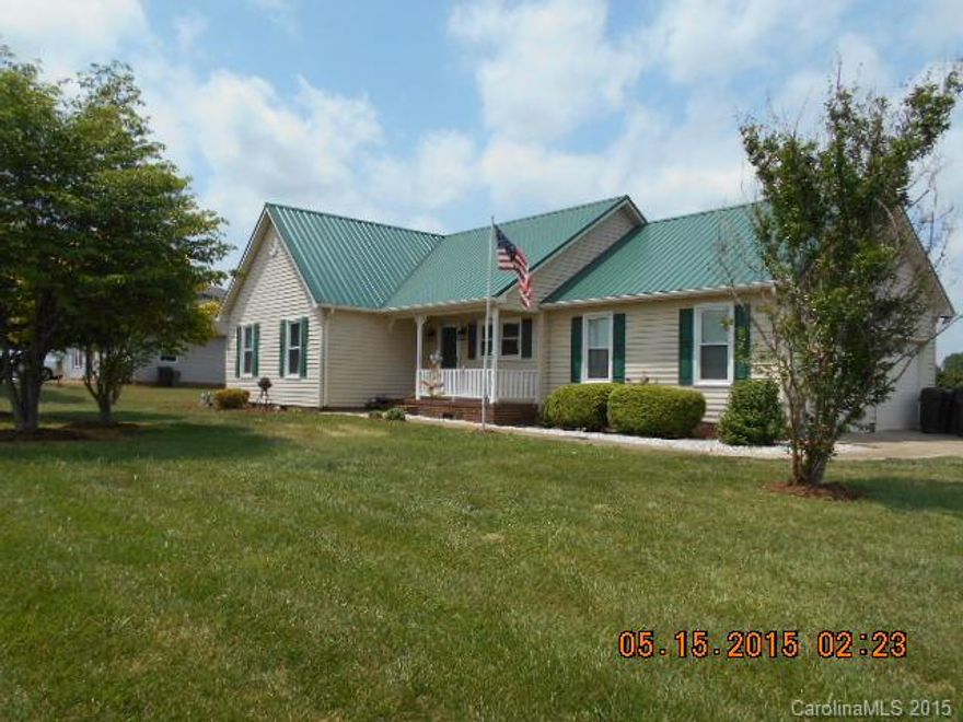 Ready to move-in. A very nice home with hardwood floors in all rooms except kitchen. Ceramic tile in bathrooms.  Solid surface kitchen counters. Eating bar in kitchen, dishwasher 1-yr, washer and dryer 3 years, refrigerator 9 years, metal roof and replacement windows 3-yrs old, French doors 2-yrs and new front door. Alarm system. Nice outbuilding.  Pretty lawn. 1-yr home warranty.