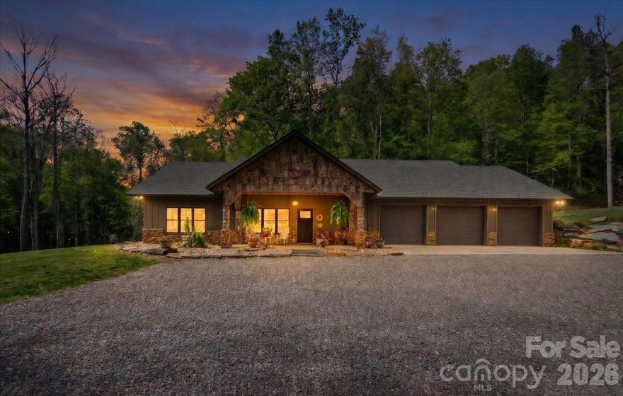 Forest Springs Lodge brings Montana to Western North Carolina. Living right on Big Crabtree Creek (known for its native trout) and 17 acres that partially boarders the National Forest offers a rare level of solitude.  The kitchen is a chef’s dream consisting of a ZLINE gas range, microwave and a Sub-Zero refrigerator, along with granite counter tops, a farm sink, spacious kitchen bar and a large walk-in pantry.  Large back patio off the kitchen is great for relaxation while listening to the bold creek flow by. The spacious open concept of dining room, kitchen and living room make it great for family gathers and entertaining, while warming up to the cozy fireplace on cold winter days.  The split floor plan with 3 bedroom/ 3 bath is great for privacy, and having ensuite baths for every bedroom is a premium touch that guests or family members will love. In the primary suite is a walk-in tile shower and soaking tub creating a true spa-like retreat, while the walk-in closets and in-suite laundry add serious practical value. Also, off the primary bedroom is an office for those who wish to work from home.  A 3-car attached garage plus a dedicated 42 x 26 ft. RV garage and workshop is a dream for hobbyists, woodworkers, or anyone needing to store outdoor gear for exploring the nearby creek and forest.  Close to the Blue Ridge Parkway for hiking enthusiasts, Spruce Pine is 30 mins and Burnsville 30 min drive.