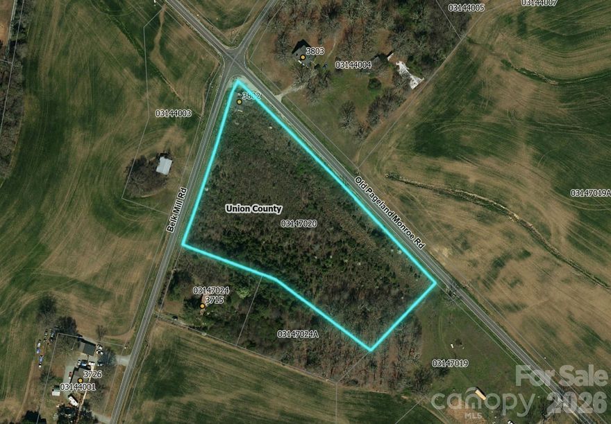This ±5.72-acre parcel sits at the corner of Belk Mill Rd and Old Pageland Monroe Rd, offering excellent visibility and access. There is an old retail building on the corner conveyed at no value. Primarily zoned RA-40 with a corner section zoned B2 through Union County. This would be great for a private home site, or small development through subdividing within current zoning rules. Lot lines in pictures are approximate.