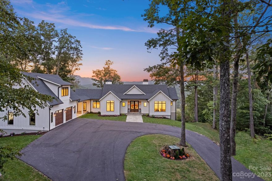 This remarkable 7BR, 5.5BA home on 6.41 acres blends modern farmhouse charm with stunning mountain living, ONLY 5 MINUTES to historic downtown Hendersonville. Revel in the breathtaking mountain views from every angle. Four inviting fireplaces grace this spacious home, creating a cozy ambiance.

The three-car garage boasts a full apartment, perfect for guests or income potential. Accordion glass doors lead to an expansive deck with a fireplace, ideal for relaxation. On the lower level, a spacious game room with a wet bar invites entertaining, while the flagstone patio offers serene outdoor retreats.

Experience the perfect fusion of modern luxury and rustic beauty in this incredible home. With views that inspire, spaces that delight, and a location that combines convenience with serenity, this property epitomizes the finest in mountain living.