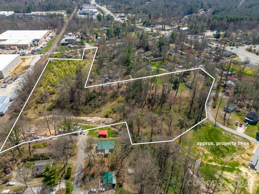 Investor alert. 6.94 acres MOL (all pins added together equal 7.44 acres- Seller is retaining .50 MOL acres so total for sale is 6.94 MOL). Zoned local commercial. Mostly cleared w/ over 600 ft of railroad frontage.  Behind Mtn. Home Fire Department and extends to railroad across from Clement Pappas NC LLC and Stagg Mountain Home LLC Industries.  10 lots including home to be sold as one parcel or will split off home and sell land separately.Conveniently located only 2.5 miles off Fletcher exit of I 26.Lot begins approximately 430 feet from Highway 25/Asheville Highway.  It is behind Mountain Home, fire department and can be seen from Highway 25. City water is in place. Charming 1292 sqft hm features hardwood flrs and could be remodeled for ofc space. Home does not have heat and needs updates including a roof. Small leak near chimney. 2 fire hydrants are located within 300 feet of property.  Acreage is approximate it will need to be surveyed prior to closing.  May be split from house.
