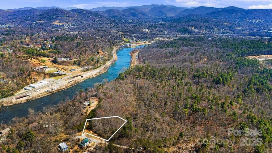 Don't miss this rare opportunity to build your dream home overlooking Richmond Hill Park's currently expanding hiking and mountain biking trails and disc golf course. Five minutes from Taylor's Wave River Park (which survived Helene and is moving forward). Grab a morning walk or bike in the woods, surf and turf play after work. 10 minutes to the heart of Asheville's delightful variety of food, drink, culture and music. Inside Woodfin city limits, zoned R10, semi private road maintenance agreement, no mobiles allowed, but no other restrictions, covenants or HOAs. Mix of flat and sloping land, but none in the steep slope ordinance (recent topo surveys attached). Per Woodfin in 2020, there is room for one more water tap on the road, with underground line already placed (first come first served).