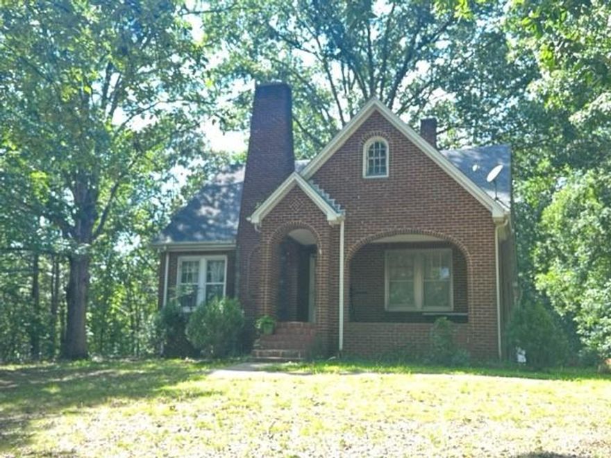 The home's 1940s charm sets the stage for a transformation into a modern and functional living space. While this all-brick exterior home with over 2300 square feet of living space currently requires major updates and renovations, its classic features provide a strong foundation for a remarkable restoration. Investors with a keen eye for design and the ability to envision the possibilities will find this property an enticing canvas to bring their creative ideas to life. There are 5 bedrooms, a family room, an office, a family room and keeping room! Nestled on a private lot that sits back off the road with a covered front porch and backs up to a serene, wooded area, this property offers a peaceful retreat from the hustle and bustle of city life. Its location also provides very easy access to Highways 70, 40 & 321 and nearby amenities, schools, & shopping centers, making it an attractive choice for many looking to settle in a tranquil yet convenient setting. Selling as is.