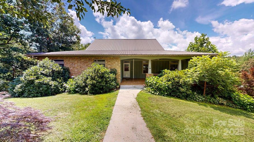 Price Improvement!  This turn-Key Property with Secondary Living Space – 20 Minutes to Asheville

Pre-inspected and ready for occupancy. 4 BR / 3 BA / 3,351 sq ft home on 1.32 acres with long-range mountain views.

MAIN LEVEL
• Large living area with Brazilian cherry floors and 3-sided gas fireplace
• Custom cherry kitchen
• Approx. 50 ft of covered rear deck
• Screened balcony off upper-level office

PRIMARY SUITE
• Walk-in closet
• Jetted tub with mountain views
• Dual sinks

LOWER LEVEL / SEPARATE LIVING AREA
• Fully finished walk-out basement with separate entrance
• Bedroom with walk-in closet and private full bath
• Living area
• Plumbing in place for a second kitchen (buyer to verify use and permitting)
• Private lower deck

ENERGY FEATURES
• 17 kW solar array with seven Tesla Powerwalls (per seller)
• Level-2 EV charger installed
• Three newer high-efficiency mini-splits

EXTERIOR & HOMESTEAD FEATURES
• Approx. 300 linear feet of established garden beds and four raised beds
• Greenhouse, fruit trees, chicken coop with run, and goat shed
• Partially fenced yard
• 32×20 detached open barn
• Additional unfinished 1 BR / 1 BA studio cottage with kitchen (not included in sq ft; buyer to verify permitting and potential uses)

ADDITIONAL PROPERTY DETAILS
• Two-car basement garage with EV charger
• Covered RV/boat carport with 30-amp hookup
• Concrete driveway
• Approx. 20 minutes to downtown Asheville and 12 minutes to major grocery stores

Schedule your showing today.