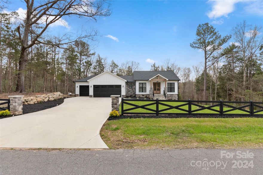 Fall in love with this wonderful custom home that was made for entertaining. Situated on a private one acre lot, this home has been thoughtfully built with no detail overlooked. Enjoy 10ft ceilings in the main living area and a fully equipped kitchen with beautiful ceiling height cabinetry and large Cosmo gas range. Bonus butler's pantry is tucked away offering additional storage, prep space, and wine fridge. Off the kitchen, step through 8ft double doors into a stunning 3 season room with EZE Breeze windows and expansive stone fireplace. Wall heater and oversized ceiling fan allow you to enjoy this room any time of the year and you will definitely want to be out there all the time! Other notable features include: Beautiful 3/4 inch Ash hardwood floors & Quartz countertops throughout, Spacious laundry room, Built-in drop zone, Smart switches, & tankless water heater. Plentiful storage under the house(with 11x11 slab) and a 3 car garage will ensure you have a place for everything.