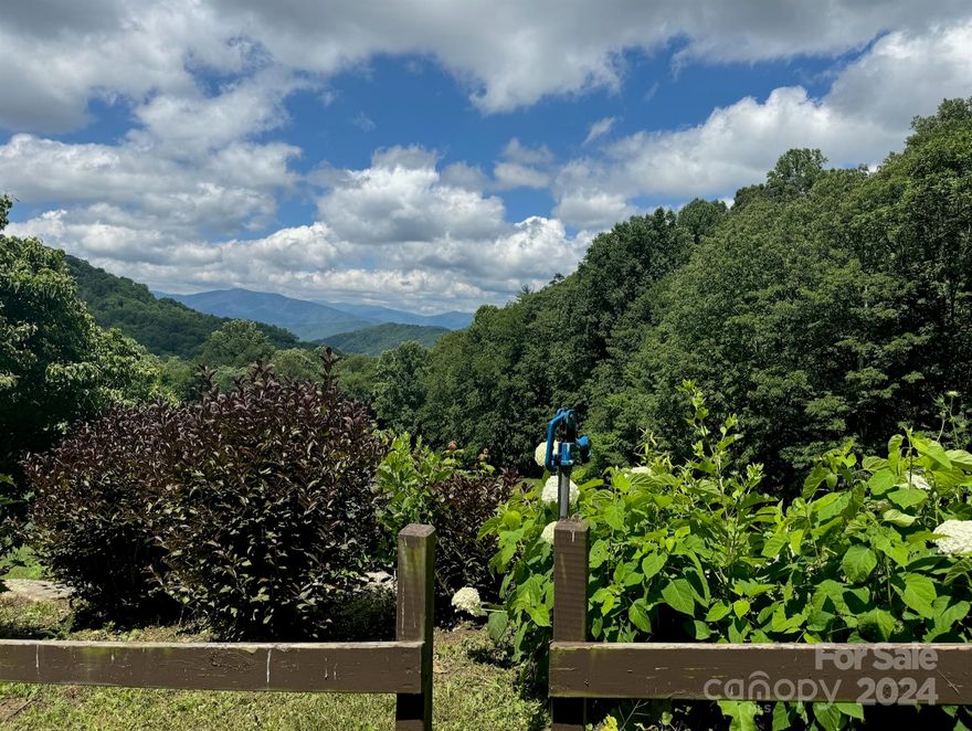 Welcome to your future home site in the picturesque Wolf Creek Ranch community, nestled in the heart of Haywood County. This 3.17-acre lot offers stunning, unobstructed views of the majestic Western North Carolina landscape.

As you explore the property, you'll first encounter the Mail Barn, which provides convenient storage for packages and a secure, gated entrance. The lot features private gravel road access and electricity access boxes at road, making it ready for your dream project.

Your new home will be perfectly situated across from a charming community gazebo, complete with seating, a fire pit, and beautifully maintained landscaping, all set against the backdrop of a classic barn.

Located just an hour from Asheville Regional Airport and downtown Asheville, you'll have easy access to the city's renowned restaurants, vibrant art scene, craft breweries, and a wealth of outdoor activities.