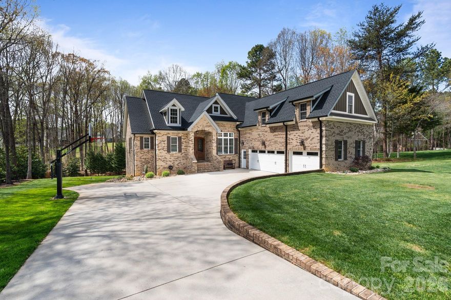 Tucked at the back of a desirable neighborhood in Mooresville, this 1.5-story home offers privacy, luxury, and thoughtful design. Situated on a large, secluded lot with a wooded backyard, enjoy serene mornings, abundant wildlife, and a true sense of retreat, all just minutes from Troutman and Lake Norman.
The open floor plan creates a bright, welcoming flow perfect for family living and entertaining. The main level features a primary en-suite with a luxurious soaking tub and two additional bedrooms, while upstairs provides a fourth bedroom and a spacious bonus or flex room, ideal for guests, a private retreat, or optional in-law accommodations.
The walkout basement offers flexibility and future potential. Currently partially finished, it includes a workshop, a small kitchenette with sink and refrigerator, and a room being used as a workout space. This space can be customized for recreation, hobbies, or additional finished living areas.
Outside, an inground pool with fountains creates a resort-like atmosphere. Pristine landscaping and an in-ground irrigation system enhance the backyard, framed by a peaceful wooded backdrop. The oversized three-car garage provides ample space for vehicles, storage, and projects.
Additional highlights include a whole-house water filtration system, recently pumped septic system, new heat pumps installed in 2022, new roof 2022, and leafblaster pro gutter guards. With easy access to major expressways, this home combines convenience with a tranquil lifestyle.
This exceptional home is meticulously maintained, move-in ready, and designed for those who value space, quality, and a connection to nature.