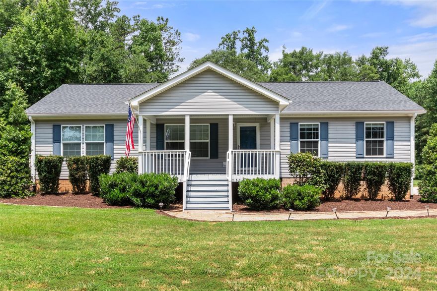 Escape to the country and enjoy true peaceful living on a beautiful SIX ACRES, yet still be just minutes to I-77. This wonderful ranch home, built in 2017, has a covered front porch, a covered back deck, and is waiting for you to come relax, or entertain smaller or larger groups. With 3 bedrooms and 2 bathrooms, this home is nestled on a partially wooded lot, with a lovely fire-pit, raised beds for your vegetables, a large shed and a chicken-coop. Enjoy the open floor plan of family room (with fireplace), kitchen (with island, stainless appliances and walk in pantry) and dining area that overlooks the rear of the property. The homes interior is fresh and move-in ready, and is wonderful for your day-to-day living, entertaining and relaxing. With plenty of space to park all your vehicles, including any sporting/recreational vehicles you may have. And all this on 6 acres with No HOA! If privacy is your goal then look no further as this home is surrounded by beautiful wooded land.