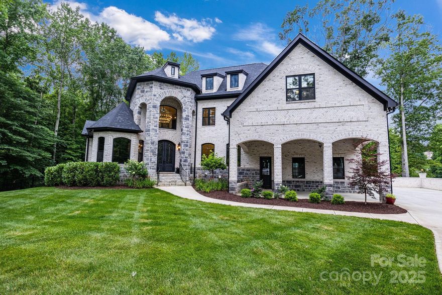 Welcome! This custom-built home in the gated community of Park Creek - BridgeMoore Estates, is situated on a private 1.83-acre corner lot on a cul-de-sac, this 3-story brick home offers wooded serenity, a fenced backyard, and curb appeal. 
Inside, a striking 3-story spiral staircase and open floor plan welcome you, with expansive windows showcasing the backyard views.The main level boasts 21' ceilings in the foyer, great room, and dining room, along with Hickory hardwoods, home office, and a luxurious primary suite with marble shower, dual vanities, and laundry hookup. The gourmet kitchen features two islands, Wolf range, double dishwashers, wine closet, and walk-in pantry—perfect for entertaining.
Upstairs offers 3 en-suite bedrooms, an office, and storage room. The walk-out basement provides ultimate flexibility with 3 flex rooms, 2 full baths, utility room, a spacious rec room, and wet bar. Additional highlights include a 3-car garage with 13.5' ceilings and a porte-cochere.