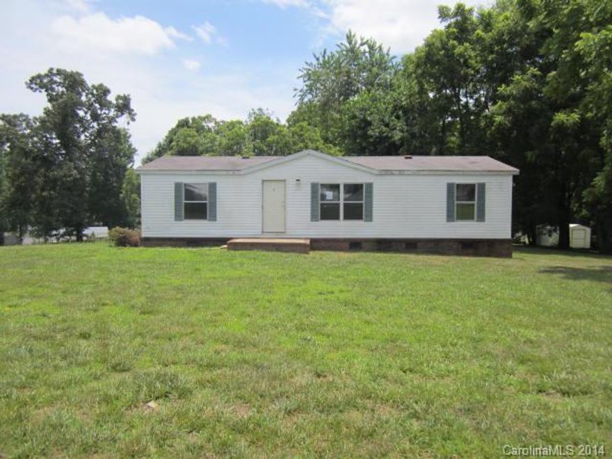 Manufactured doublewide home on 0.58 acre corner lot with 3 bedrooms, 2 baths, kitchen, and living room. Home features neutral colors, master bath with garden tub and double sinks, and breakfast bar. Features include deck and fenced backyard perfect for entertaining.