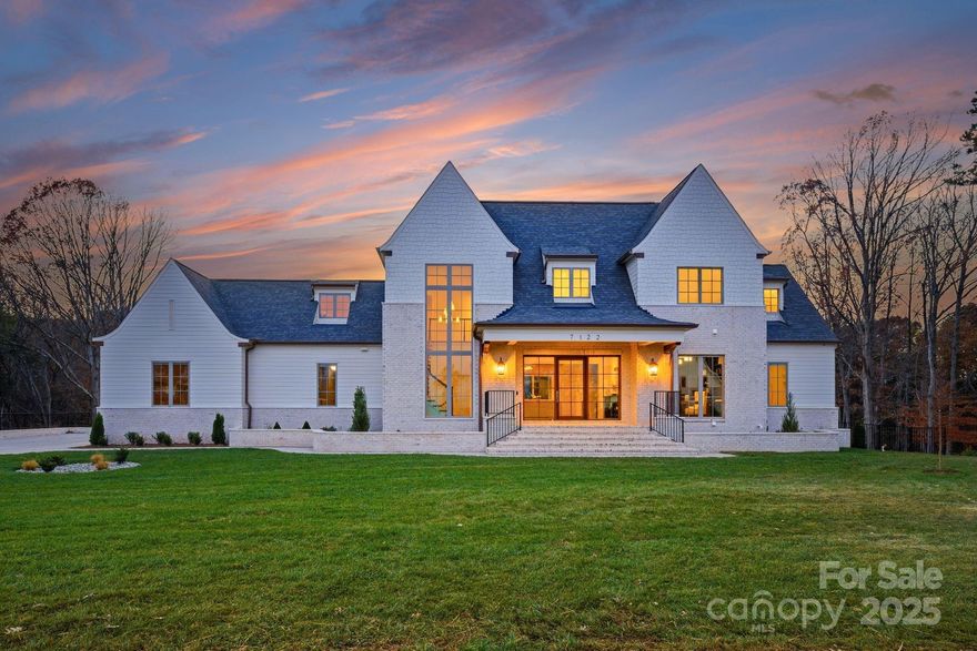 Experience unparalleled luxury in this bespoke 3-story new-construction estate, perfectly sited on 7.25 private acres and crafted with impeccable attention to detail. This 6-bedroom, 6.5-bathroom, with 3 car garage residence blends timeless sophistication with elevated modern amenities, offering an in-ground resort-style pool with hot tub, fire features, and multiple outdoor living spaces designed for year-round enjoyment. A grand foyer with a soaring staircase sets the tone for the thoughtful design throughout. The gourmet kitchen features premium custom cabinetry, a massive island ideal for entertaining, and expansive  storage in the butler’s pantry. A dedicated mudroom includes built-ins, laundry, and a convenient dog-feeding station with water access.
The main-level luxury primary bedroom suite offers a fireplace, spa-inspired bath with an oversized shower, freestanding tub, stackable laundry area, and two spacious custom closets. An additional bedroom—styled perfectly for a home office—plus a full bathroom complete the main level. Accordion-style sliding glass doors open to a covered outdoor porch with fireplace, retractable screens, and a winding exterior staircase leading down to the pool terrace. 
The upper level offers three well-appointed bedrooms, each with its own ensuite bathroom, plus a large bonus room with half bath, dedicated laundry room, and generous unfinished storage.
Designed for elevated entertaining, the basement includes a speakeasy-inspired bar/kitchenette, media-style living room, a separate sitting lounge area, an additional bedroom/gym and full bathroom, and a covered heated porch with direct access to the resort-style pool.
A luxury residence where privacy, craftsmanship, and sophistication come together seamlessly. This home delivers the ultimate retreat—both inside and out. Original Contract Price: $3,600,000