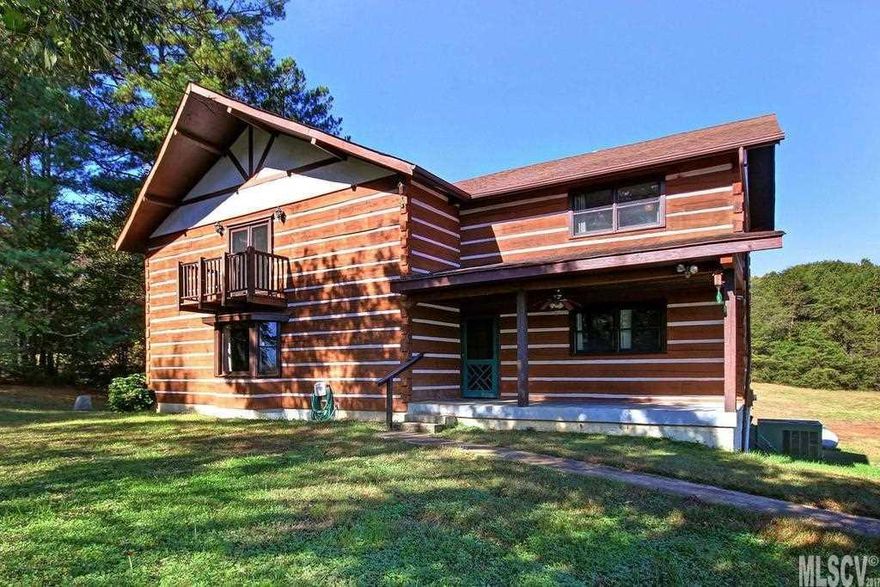 Sits far off main rd. with 2 choices of entrance, well built log cabin, a frame completed for pole barn, fenced in area for dogs,chickens/goats with enclosures. Minutes to shopping and I-40. New deck, HVAC 2013, Goodman 95.5% efficient propane furnace. New gas range, with one electric and one gas oven. New deck, craft room or office upstairs with counters and shelving. Charter internet and direct TV available. Natural spring on rt side of back of property could become pond.