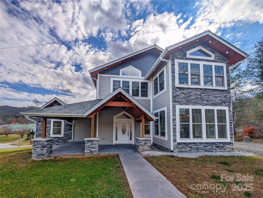 Discover exceptional craftsmanship and modern luxury in this high-end 4-bedroom, 3 full-bath + 2 half-bath residence, thoughtfully designed to accommodate both elegant living and business flexibility. Step inside to a bright open-concept main level featuring a welcoming foyer, chef’s kitchen with specialty appliances, a spacious dining area, and a comfortable living room that flow seamlessly together—perfect for entertaining or everyday living. The main level also includes two ensuite bedrooms, a half bath, laundry room, walk-in pantry, and under-stair storage. Upstairs, the open-concept Great Room serves as the heart of the home, centered around a stone fireplace that exudes warmth and character. You’ll also find a second laundry area, two additional bedrooms with walk-in closets, a dual-entry full bathroom, and a separate half bath for added convenience. Every feature of this home has been elevated for comfort and sophistication—heated bathroom floors, recessed lighting, WiFi-enabled smart switches with dimmers, smart-key door locks, power pop-up kitchen outlets with wireless phone chargers, specialty appliances, and a specially engineered roof system paired with extra foam insulation for superior sound and temperature control. (See attached full specification list for details.) With no zoning restrictions and direct access to a major highway, this property offers incredible versatility—ideal for a private residence, business, or a hybrid live/work setup. An additional 1.16 acres (originally acquired via NC DOT) is also available for purchase from the owner, providing even more opportunity to expand. Don’t miss this rare opportunity to experience quality craftsmanship, modern innovation, and prime location in one remarkable property. Schedule your private tour today!