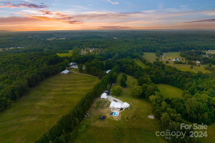 The Oaks.  An extraordinary lifestyle gated estate on 88 beautiful acres with extensive manicured landscaping.  Imagine two primary homes, multiple ancillary buildings, rolling open meadows and private forest, - it defines itself with tranquility and privacy. Just 15 min from downtown Salisbury and 45 minutes from Charlotte Airport, The Oaks is what you desire - whether a relaxing private compound or an income producing venture.  Currently a private estate and wedding venue, it has incredible potential for equestrian facilities (private or professional), bed & breakfast or continue its track record as a successful wedding venue.  New owner/developers are invited to consider establishing additional homesites.  Each primary home has it's own private drive and address.  Each home is completely private from the other.  Both are uniquely modern and gorgeous. Consisting of 5 parcels, 7 wells, buried utilities, rolling pastures, mature forest and privacy.  Live your dream at The Oaks!