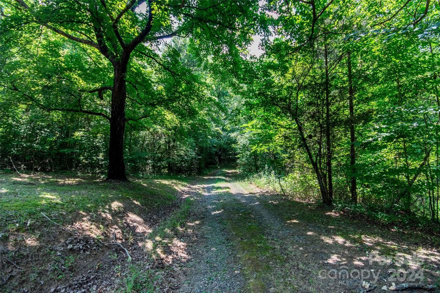Hard to find, 6.7 acre property in North Iredell Area!  Private and heavily wooded parcel. Harmony address and very close to the Old Mocksville Road intersection. This property has an existing brick home and outbuildings that will convey at no value. Located in a farmland buffer. The home has not been occupied in approximately 6 years. No meter. Energy United is provider. Property does have private well and septic (no permits located online).  Acreage was recently recombined and the new parcel ID is noted here.  Tax value, per seller documents from county is $162320. Home has extensive termite damage and active termites. Seller is selling AS-IS, WHERE IS with any contents on site at closing. Buyer will need to provide generator on site if inspecting well during due diligence.