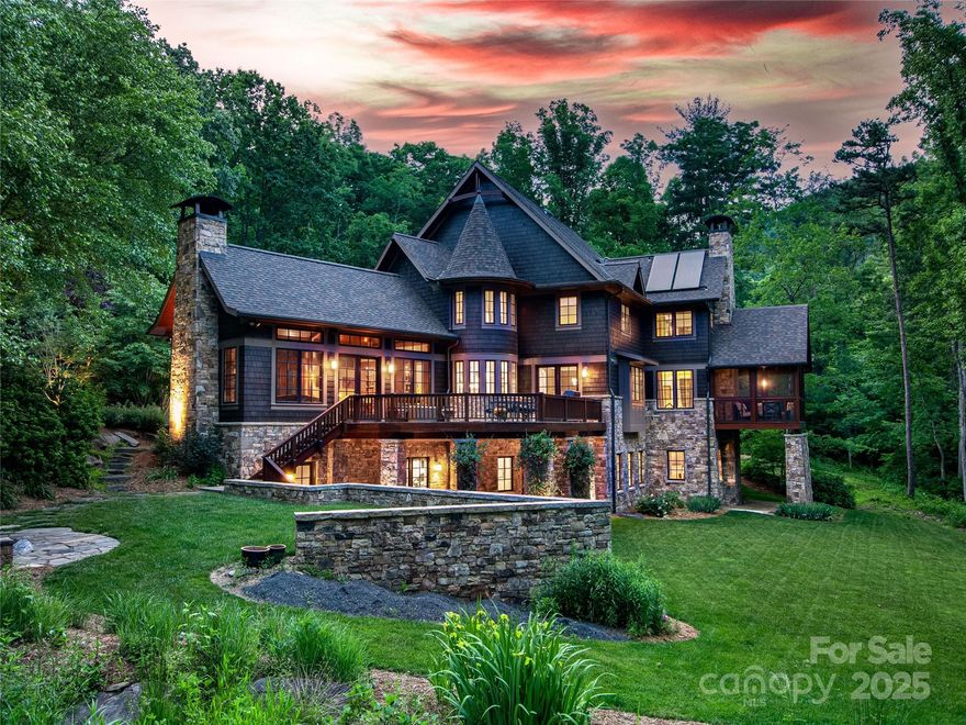 Discover the ultimate in luxury living with this stunning North Asheville masterpiece. Perfectly nestled in a mountain setting with a 95-acre conservation surrounding the mountains, the home blends timeless natural materials like Canadian red cedar shingles and regional stone with sustainable green technologies, including solar-assisted hot water and some radiant floor heating. Impeccable craftsmanship shines with over 5,000 board feet of reclaimed site lumber used for custom cabinetry, doors, and trim. Paired with luxurious finishes, premium appliances from Wolf, Sub-Zero, and Miele create a home of unmatched refinement. Designed for grand entertaining and family living, this home features two private offices, a home gym, and professionally landscaped outdoor spaces with a fenced backyard. Whether hosting under the stars or enjoying quiet mountain serenity, this residence offers elegance, sustainability, and unparalleled comfort.