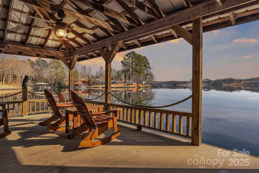 Nestled in a quiet, private cove on the pristine waters of Lake Hickory, this exceptional lakefront home built in 2020 offers the perfect blend of modern comfort, thoughtful design, and year-round waterfront living. With 200 + feet of beautiful shoreline, breathtaking water views, and a well-built stationary dock complete with boat lift, this property is a rare opportunity to own a premier slice of one of Western North Carolina’s most desirable lakes. The home features 3 spacious bedrooms, 2 full bathrooms, and a dedicated office, ideal for remote work, creative space, or a quiet retreat from the main living areas. Designed with both functionality and flow in mind, the open-concept layout seamlessly connects the living, dining, kitchen, and den areas—each positioned to capture peaceful lake views and natural light. The heart of the home is warm and welcoming, making it equally suited for everyday living or entertaining family and friends. The kitchen is thoughtfully appointed with modern finishes, ample cabinetry, and generous counter space, opening effortlessly into the main living area for easy hosting. The primary suite offers a relaxing escape, a well-designed en-suite bath, and generous closet space. Two additional bedrooms provide comfort and flexibility for guests, family, or hobbies, while the separate office adds valuable versatility rarely found in lake homes. Step outside to experience true lake living. The gently sloping lot leads to 205 feet of shoreline, providing expansive water frontage, stunning views, and easy access to the lake. The stationary dock with boat lift is solidly constructed and perfectly positioned within the protected cove—ideal for boating, kayaking, paddleboarding, fishing, or simply enjoying peaceful mornings and sunset evenings by the water. Whether hosting summer gatherings or savoring quiet moments lakeside, this outdoor space is designed to be enjoyed year-round. Located in a tranquil cove yet convenient to local amenities, this property offers privacy without isolation. Built in 2020, the home reflects modern construction standards, low-maintenance living, and thoughtful design choices throughout. Whether you’re seeking a full-time residence, a weekend escape, or a long-term investment in lakefront living, this Lake Hickory home delivers comfort, quality, and an unmatched waterfront lifestyle. Homes with this combination of newer construction, office space, protected cove location, expansive frontage, and a boat-lift dock are exceptionally rare. Don’t miss your opportunity to own a turn-key lakefront retreat where every day feels like a getaway.