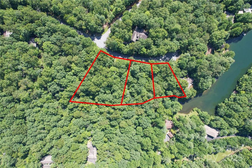 Two Acres of flat usable lake front land on Lake Wanteska. This sale includes 3 lots totaling over 2 acres found at the end of a very private culdesac close to the Walnut Hollow gate. You can build up to 3 homes or combine all the lots for one very private and versatile estate lot on the clearest and most private lake in Connestee Falls. There are multiple home sites on this land and lots of room for out buildings like a workshop, a sauna and an artist studio. The dock would be ideally located at the western corner of the property in the private cove where a running stream flows into the lake. The stream runs along the property line of these lots on POA green space and can be enjoyed by the new owner of this property. A favorite building site would be perched above the ridge looking out over the lake with a very short walk down to the waters edge and an easy winding driveway through the trees. As a Connestee Falls resident, you’ll have access to over 20 miles of pristine hiking trails, six waterfalls, an 18-hole designer golf course, pickleball and tennis courts, pool facilities, and exceptional dining options. Seller is NC Licensed Realtor and the listing agent.