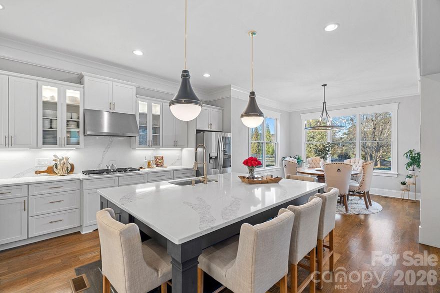 This masterfully reimagined home, situated within The Point, represents the pinnacle of lakeside luxury and modern sophistication. Every square inch of this residence has been meticulously curated through a top-to-bottom transformation, offering a "like-new" experience that is entirely move-in ready. Welcoming you home is a classic rocking chair brick front porch, perfect for enjoying the quiet elegance of the neighborhood. Upon entering, the interior reveals a seamless blend of comfort and style with a fresh designer palette applied to every wall. The wide Oak hardwood floors throughout the entire home have been beautifully refinished, providing a warm and consistent foundation for the home. Natural light pours through, controlled by new plantation shutters installed on the windows, offering a perfect balance of privacy and brightness.

The main level is designed for both grand entertaining and intimate daily living. The formal dining room makes a sophisticated statement with custom wainscot panels, while a private office provides a quiet retreat for remote work. The heart of the home is the chef’s kitchen, which has undergone a comprehensive overhaul. This culinary space features professionally refreshed cabinetry with sleek new hardware and glass-front displays enhanced by new in-cabinet and under-cabinet lighting. Premium Quartz countertops provide a seamless transition as they wrap from the counters to also cover the backsplash. The centerpiece is a large, custom-built island topped with stylish quartz, featuring integrated storage and ample space for casual dining. The kitchen is equipped with a newer high-end appliance suite, including a French door refrigerator, dual oven and microwave combo, a high-performance range, and a stainless steel hood. This space opens directly to the expansive Great Room, anchored by a cozy gas fireplace and elegant built-in cabinetry. For effortless access between floors, a pneumatic elevator connects the main and second level. Throughout the home, all-new designer light fixtures ensure every room is illuminated with modern brilliance.

The sizable primary suite serves as a private sanctuary, featuring refinished hardwood floors, a cooling ceiling fan, and expansive his-and-her walk-in custom closets. The ensuite bathroom has been completely remodeled to rival a five-star spa, showcasing a freestanding soaking tub and an expanded walk-in shower with dual shower heads and a stylish accented tile niche. The floor is laid with large-format tile, creating a sleek, expansive feel, while two new white oak vanities with modern lighting complete the luxury experience. This commitment to quality extends to all secondary bedrooms, which feature walk-in closets and access to bathrooms that have also been fully remodeled with updated surfaces and modern fixtures. On the third level, a versatile bonus room provides flexible space for a home gym, a second office, or a dedicated family media room.

Outdoor living is a standout feature of this property. The rear of the home boasts a large covered deck, ideal for year-round lounging and dining, which leads to a dedicated fire pit area perfect for evening gatherings under the stars. The flat, private backyard is fully fenced and serves as a pristine blank canvas, perfectly leveled and ready for a custom POOL. Beyond the property lines, the lifestyle is unparalleled; the home includes a leased boat slip at the highly coveted Pier Z, providing immediate access to the deep waters of Lake Norman. Situated moments from the world-class amenities of Trump National Golf Club, this property is an invitation to experience the very best of Carolina lakefront living in a residence that has been flawlessly updated.