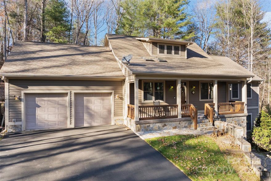 Beautifully crafted and exceptionally private, this former builders personal home offers quality construction and thoughtful upgrades. The main living area features a stone fireplace, vaulted ceiling, hardwood floors, and an easy flow into the dining area and open kitchen with stainless appliances. French doors lead to a peaceful rear deck ideal for entertaining. The main level includes a spacious primary suite and a second bedroom for comfortable one-level living. Downstairs provides a large guest bedroom, office or sitting area, full bath, and a generous unfinished space for storage or future expansion. An oversized two-car garage, low-maintenance landscaping, and extensive stonework add to the appeal. Enjoy a classic rocking-chair front porch with automated screens overlooking wooded surroundings. Minutes to downtown Hendersonville, summer camps, DuPont State Forest, and more.