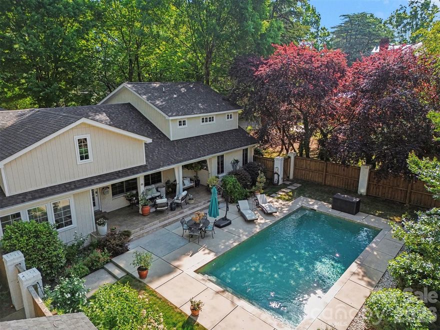 Step into timeless style and modern comfort with this beautifully updated 1950s ranch, perfectly located just moments from downtown Monroe’s boutiques, restaurants, and parks. Spanning over 4,300 sq ft, this thoughtfully designed 4-bedroom, 3.5-bath home offers seamless flow between open living spaces, ideal for entertaining or everyday living. Dual primary suites each feature private en-suite baths and spacious dual closets, perfect for guests or multigenerational living. A stunning custom kitchen boasts handcrafted cabinetry, a coffee and tea bar with under-counter refrigerator, built-in microwave, and a convenient pot filler above the range. Every detail combines elegance and ease, from the beautifully wallpapered powder room and touch-free toilets to restored original features like a crystal chandelier and fireplace mantel. Light pours through new energy-efficient Andersen windows, while custom draperies add warmth and sophistication. Step outside to a peaceful retreat surrounded by lush landscaping and a zen-inspired pool area designed for relaxation. A climate-controlled wine cellar, spacious laundry with utility sink, and whole-home security system offer comfort and confidence throughout.