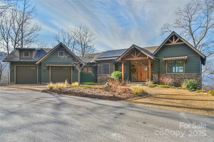 Discover 392 High Hickory Trail, a Green Built Certified home offering unobstructed & layered views of the Blue Ridge Mountains year-round. Built in 2020 with exceptional attention to detail, this energy-efficient home features a 12.7 kW solar system and a 13 kW generator, ensuring sustainability and reliability.
Step inside to an open and inviting layout, featuring a main-level primary suite and high-end finishes throughout. The heart of the home is the light-filled great room, flowing to the main level covered deck. Downstairs you'll find another living room, two bedrooms and the second covered deck w/ hot tub. Set on 2.2 acres, the property boasts a large flat yard, ideal for hosting and great for pets. The spacious 2-car garage with heat/AC  is outfitted with a dog wash station and a level 2 EV charger, adding extra convenience. Located in the coveted High Hickory gated community, this home offers convenient access to I-40. Drone Video : https://vimeo.com/1037971168