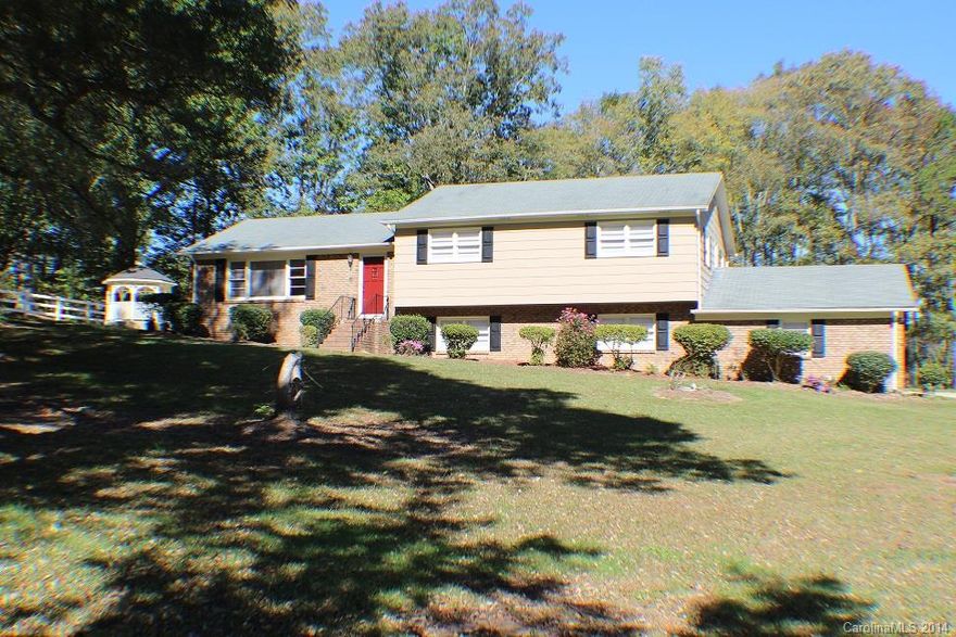 COMPLETELY UPDATED!! NEW Kitchen C-tops, Stamped Metal Backsplash, Appliances, Sink, Faucet, Cabinet Hinges & Knobs! Huge Family Room w/ Fireplace! Living Room-Dining Room Combo & Breakfast Nook. All 3 Bathrooms have NEW Sinks, Faucets, Lights, Vanities w/ Tiled Floors. All 4 Bedrooms have NEW Ceiling Fans & Light Fixtures. Lovely Mixture of Hardwood, Tile & Carpeted Floor Coverings. A Very Private Wooded 1.3 Acre Lot. Two Car Attached Carport & Detached Workshop w/ Electricity!