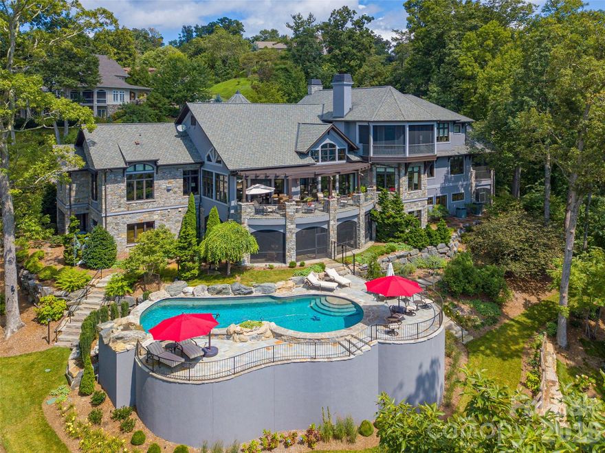 This exceptional estate, masterfully crafted by the renowned Morgan-Keefe Builders and visionary architect Alice Dodson, represents a rare intersection of architectural pedigree and an incomparable natural setting. Perched on 2.4 private, lushly landscaped acres, this residence offers a sense of seclusion and tranquility,  all while being situated in one of the area's most prestigious and quiet neighborhoods. The crown jewel of this property is its breathtaking 180-degree panoramic vista. From nearly every vantage point, you are treated to a visual symphony that includes the vibrant skyline of Downtown Asheville, the historic Grove Park Inn, the shimmering waters of Beaver Lake, and the French Broad River. The gaze extends to the iconic silhouette of Mt. Pisgah and layer upon layer of the Blue Ridge Mountains. Whether it is the morning mist rising off the river or the twinkling city lights at night, the views here are a dynamic work of art. Designed for longevity and ease of use, the primary living areas are conveniently located on the main entry level. This includes a gourmet kitchen, elegant formal and informal living spaces, and a magnificent Owner’s Suite. The main level also features expansive porches that serve as outdoor living rooms, perfect for enjoying the cool mountain breezes. Home will be sold fully furnished. Some exceptions on personal items.