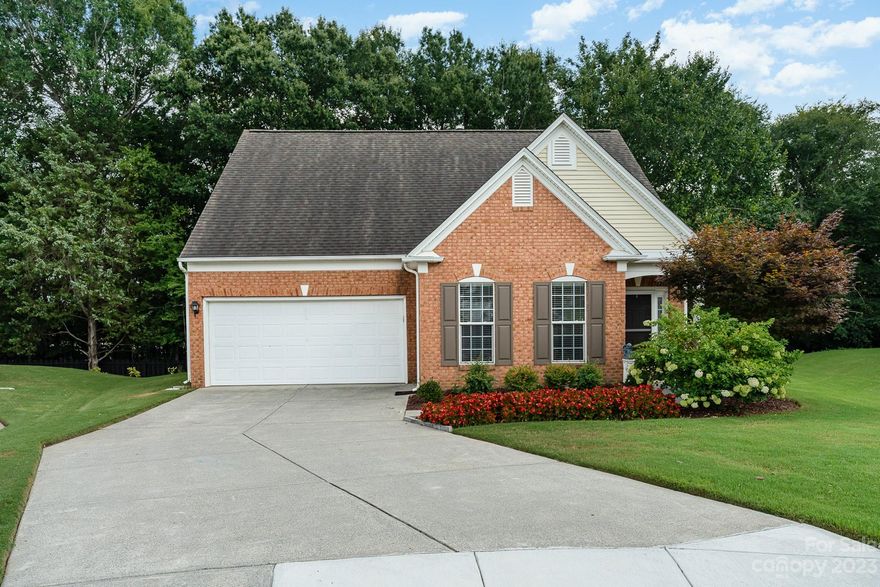 This well maintained Ashton Grove home is located in desirable Ballantyne and features an open floor plan on a wooded cul-de-sac. As you step inside, you'll appreciate the beautiful wood floors. The two story great room adds an extra touch of elegance and boasts gas logs in the fireplace, while the granite countertops and tile backsplash in the kitchen are sure to impress. The kitchen also features stainless steel appliances. The primary bedroom on main offers a tray ceiling, en suite bath with double vanities. There's also a second bedroom/office on the main level with a full bath.  Upstairs, you'll find a spacious bedroom/office with a walk-in closet and full bath. The glass enclosed patio is perfect for enjoying the outdoors in any weather, with screens and a ceiling fan to keep you comfortable. There's also a paver patio with a seating wall for outdoor entertaining. Lawn maintenance is included in the HOA!