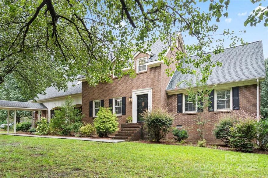Charming 4BR/2.5BA home on 3 acres in award-winning Clover School District! A tree-lined drive leads to 3,150 sq ft of living space featuring formal living & dining rooms, cozy den with wood-burning fireplace, and a bright all-seasons room with Spanish-style tile. The main floor includes a guest bedroom, laundry room, and half bath. Upstairs, the spacious primary suite offers a HUGE walk-in closet, dual vanities, and stand-up shower. Two additional bedrooms and a full bath complete the second floor. Hardwood floors throughout main living areas, carpet in bedrooms, and wood stairs. The backyard is flat, treed, and fenced—perfect for pets or play—with a charming gazebo, brick paver patio, and space for a pool. Detached 2 - car garage/workshop, backyard shed, and former garden area add extra functionality. This private, peaceful property blends Southern charm with everyday comfort—if you're moving to the Charlotte suburbs, don’t miss your chance to own a slice of Clover tranquility!