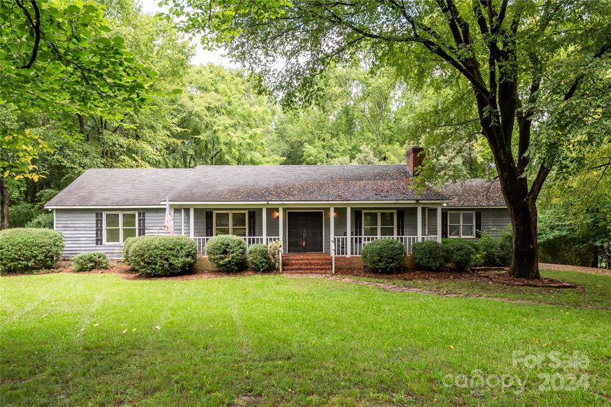 This home is located in the highly desirable Fort Mill area, known for its top-rated schools, vibrant community, and convenient access to shopping, dining, and entertainment. Nestled on a beautiful, partially wooded 2.35-acre lot, it offers a serene escape from the noise of everyday life. Enjoy your mornings with a cup of coffee on the covered front porch or in the screened-in sitting area. With plenty of room to host gatherings with family and friends, this property is perfect for entertaining. Featuring strong structural elements and enduring charm, this "as is" home invites you to reimagine and revitalize its spaces to reflect your style and needs.