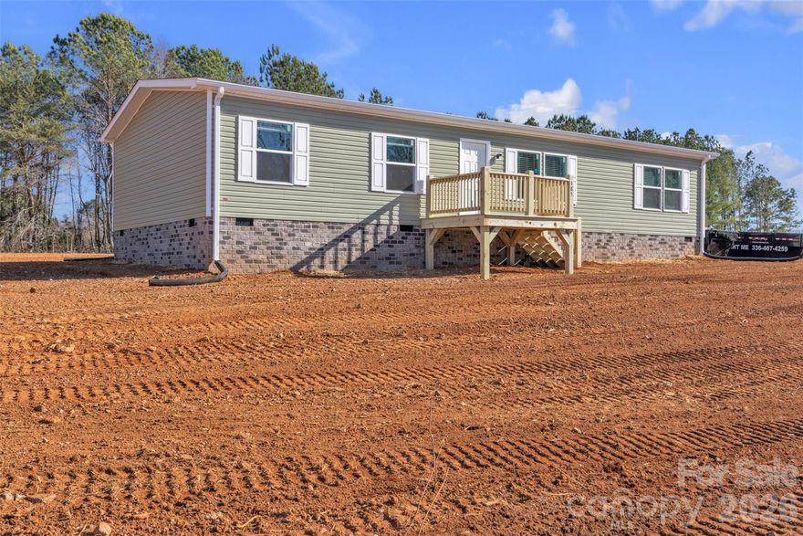 Brand new 2025 three-bedroom, two-bath Clayton home located on a cleared, level 0.756-acre lot in the desirable Wittenburg community. The home offers both front and back decks, low-maintenance vinyl siding, and gravel parking, along with a spacious backyard ready for outdoor enjoyment. Inside, the open floor plan features vinyl flooring throughout, a comfortable living area that flows into the kitchen, and a center island with all appliances included. The adjoining dining area creates an easy, functional layout for everyday living. The split-bedroom design provides two bedrooms and a full bath on one end of the home, while the private primary suite is tucked away on the opposite side with a walk-in closet and full bath. Additional living space includes an office or study—perfect for work or hobbies.  A laundry room adds extra convenience and storage.