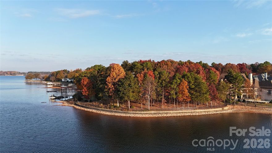 A rare opportunity to build a custom lakefront residence in The Peninsula Club on one of the last remaining homesites in Lake Norman. Tucked at the end of a quiet cul-de-sac, this exceptional property offers approximately 188 feet of shoreline, a seawall in place, and long-range, year-round water views.

Provisional plans feature 5,356 square feet of heated living space, with an additional 1,220 square feet of future lake-level space and over 8,397 square feet under roof. The design includes a three-car garage, covered porch, and a resort-style pool, with a vaulted outer garage ideal for a potential car lift.

Exterior finishes will include Old Carolina handmade brick and Hardi plank siding, aluminum-clad windows, and a Slateline 40-year shingle roof. Interior appointments include Wolf and Sub-Zero appliances, wide-plank engineered white oak flooring, and an extensive trim package with eight-foot solid core doors throughout.

The lake level offers direct access to the water, creating a seamless connection to the shoreline and flexibility for future finished living space.

With an approved dock permit and preliminary plans in place, buyers may customize the design or bring their own plans to create a fully tailored lakefront retreat in one of Lake Norman’s most established communities.