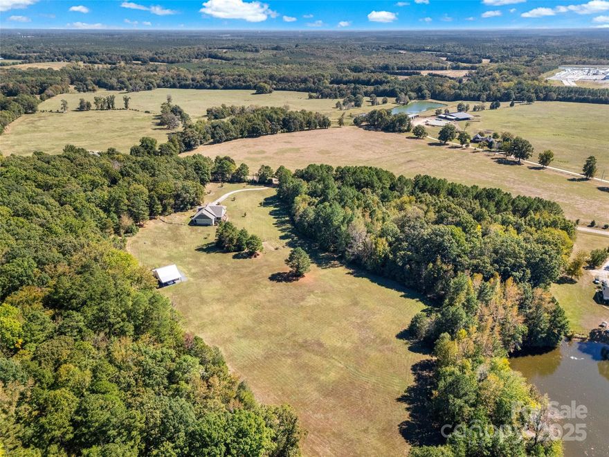 Welcome home to this beautifully maintained custom ranch by Adler Construction, perfectly set on 15 acres of peaceful rural countryside. From the moment you arrive, the rocking-chair front porch invites you to slow down and take in the open views, a true taste of Carolina country living.
Step inside to find an open, welcoming layout that blends function and charm. Natural light pours through wide windows, highlighting warm finishes and thoughtful craftsmanship. The spacious primary suite offers a serene retreat, with direct access to the covered back patio, the ideal spot for morning coffee or quiet evenings.
You’ll find plenty of room to grow your own farm or garden and feel a gentle breeze off the shared pond. With 8+ acres of pasture, this property is perfect for horses, livestock, or simply soaking in wide-open skies.
Need room to expand? The unfinished bonus room upstairs provides endless potential design for a future guest suite, hobby space or office to build instant equity. And for your equipment, hobbies or business ventures, the huge 40x40 barn delivers all the space you need.
High-speed fiber-optic internet is already on site, ensuring modern convenience meets rural tranquility. Whether your dream is a working farm, private waterfront retreat, or peaceful ranch-style homestead, this property offers it all, space, beauty, and the freedom to make it your own.