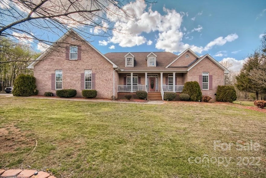 This home is the one if you've been looking for the best of both worlds.  This lovely nearly 3K square foot 1.5 story home sits on 3.5 quiet acres within city limits.  This all brick home has a desirable split floorplan with 4-BR and 3-BA, an open floorplan with granite topped kitchen island open to the family room for entertaining.  This amazing home has a welcoming front porch and a huge deck on the back.  The owner's suite sits opposite the other bedrooms with a large primary ensuite with dual walk-in closets and sinks, a linen and water closet. The spacious laundry room is large enough to hold a second refrigerator or deep freezer and can be used for additional storage on top of the fact this home has a tremendous amount of storage. There is also a storage building/shop and lots of sitting areas outside. This wonderful property is close to Downtown Concord and near restaurants and shopping at Harrisburg Town Center.