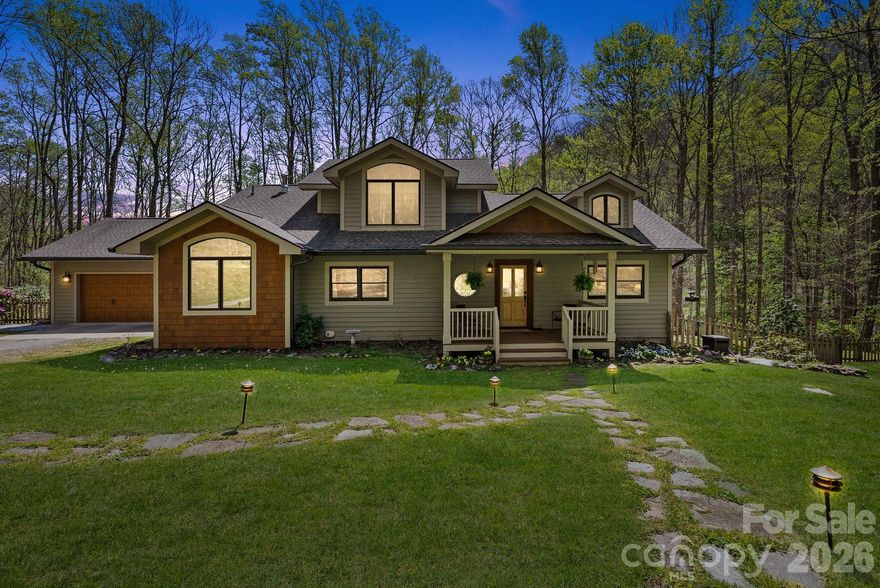 Nestled at the end of a quiet cove, this 20-acre estate invites you to call it home, with mountain views that greet you from every direction and convenient access to hiking and biking trails just moments away. The property is a living orchard and garden sanctuary, featuring three varieties of blueberries that bloom at alternating times, plus raspberries, blackberries, and mulberries, Concord grapes, seven apple trees of three varieties, a peach tree, and a pawpaw tree. Raised beds are ready for your spring plantings, and a rock retaining wall hosts a fragrant mint border that surrounds a charming outdoor oasis complete with a soothing waterfall. Beyond the lush plantings, you’ll find a larger fenced-in yard, multiple storage and utility buildings, a tractor shed, and a tranquil spiritual area with a bench and inviting paths that lead to the creek. The home adds warmth and character with a wood cooking stove and oven, while solar power with backup supplies provides sustainable living. With less than an hour to Asheville, Waynesville, and Maggie Valley, and just moments to some of the region’s best outdoor experiences, this property is a rare blend of serenity and accessibility.