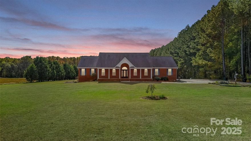 Welcome Home to 3987 Highway 27 W in Lincolnton! This full-brick, custom ranch beautifully combines comfort, function, and Southern Charm. From the moment you arrive, the welcoming rocking chair front porch invites you to sit back, relax, and enjoy peaceful views of the front yard and open fields beyond. Nestled on 7.5 serene acres with a small stream, fenced yard, above-ground salt water pool, and a versatile barn—this property is ideal for those dreaming of country living, a mini farm, or simply extra space for hobbies and toys. Inside, fresh neutral paint throughout this home, nearly 3,500 sq. ft. on the main level plus 1,900+ sq. ft. in the basement provide incredible space and flexibility for any lifestyle. The bright, open floor plan features hardwood and tile flooring, soaring ceilings, and cozy gas log fireplaces in both the great room and primary suite. The chef’s kitchen offers granite countertops, a gas cooktop, stainless steel appliances, bar seating, and a sunny breakfast area—plus a separate dining room perfect for gatherings and holidays. The spacious primary suite includes a walk-in shower and generous closet space, while three additional bedrooms and a laundry room with cabinetry complete the main level. Downstairs, the partially finished basement offers a large recreation room, full bath, and abundant storage—it could easily be finished as a second living quarters, ideal for multi-generational living, guests, or an in-law suite. Enjoy two garages—one for parking and one designed for your workshop—with a convenient lift elevator for easy access to the main level. Step outside to the rear patio and soak in the tranquility of your private retreat. Are you a gardener? You’ll love the open, sun-filled space ready for your dream garden. Don’t miss this rare opportunity—ranch-style living at its finest, with room to grow, relax, and make lasting memories! With a little TLC and your personal touch, this could truly become your dream property! Easy access to HWY 321, Lincolnton, Hickory, Vale and Surrounding areas. CLT International Airport is only 38 miles!