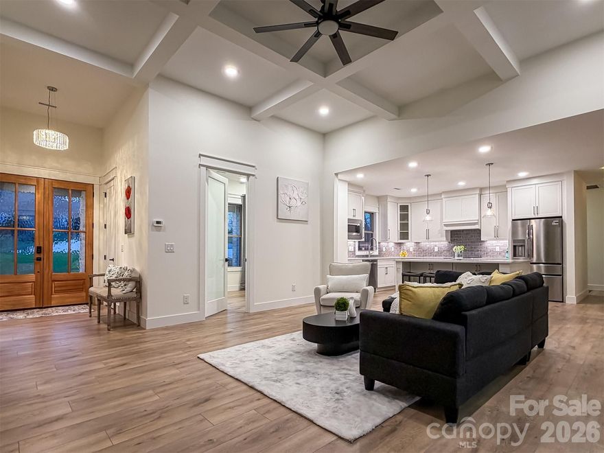 Thoughtfully designed and beautifully finished, this 4-bedroom, 2.5-bath home blends quality construction with clean, modern comfort. A full brick and Hardie® exterior creates timeless curb appeal, while inside, an open-concept layout is filled with abundant natural light from large windows and expansive glass doors. The main living areas feature 12-foot ceilings, with 9-foot ceilings throughout the remainder of the home, creating a spacious yet comfortable feel. The living room offers an inviting electric fireplace. The 4th bedroom can work well as a home office, guest space, or flex room.
The kitchen is both functional and stylish, featuring custom soft-close cabinetry, quartz countertops, a large island with seating on the living room side and cabinetry on both sides for added storage, a walk-in pantry, high-end range hood, and a modern tile backsplash—designed for everyday living as much as entertaining.
A triple-panel sliding glass door opens to a private covered porch, creating a seamless indoor-outdoor connection. Primary bathroom showcases quartz surfaces along with tiled floors and walls, including a walk-in glass shower, freestanding soaking tub, double vanity, and LED mirrors for a refined, spa-like feel. Durable waterproof laminate flooring runs throughout the main living areas, offering a scratch-resistant surface designed for long-term performance, while tiled bathroom finishes provide both style and durability.
Additional highlights include an 8-foot solid mahogany entry door, Hunter ceiling fans and light fixtures, video doorbell, and a driveway with ample parking.
The walk-out basement features 10-foot ceilings and is pre-plumbed for a future kitchen and bath, offering excellent flexibility for expansion, recreation space, or additional living arrangements.
With abundant natural light, quality materials, and thoughtful details throughout, this home delivers a well-executed balance of comfort, functionality, and lasting design.