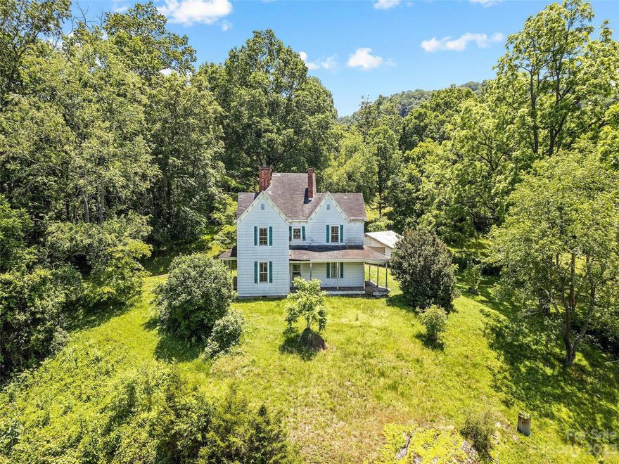 A real estate gem offering a captivating blend of natural beauty and historic charm. This farm boasts 45.143 acres with fenced pastures, perfect for livestock or equestrian enthusiasts. Bold Crabtree Creek meanders through the pastures, providing a picturesque setting and your own trout stream. A true testament to the past, a historical 1893 farm house graces the property, exuding character and inviting you to step back in time. This stately home needs a lot of TLC but is worthy of being renovated. Convenience meets tranquility with state road access to the property, allowing for easy commuting (less than 2.5 miles to I-40). Immerse yourself in breathtaking vistas as you take in the great mountain views, a constant reminder of the majestic beauty of the Blue Ridge Mountains. This property promises a blend of nature, history, and a place to call home while embracing a peaceful rural lifestyle. Don't miss the chance to make this extraordinary piece of real estate your own.