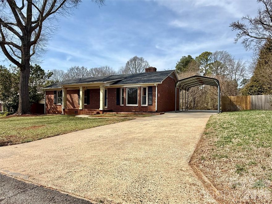 Charming brick ranch home at 1838 Townes Ct, Rock Hill, SC 29730 offers the perfect blend of timeless appeal and fresh modern updates in the desirable Harrell Estates neighborhood. There is no HOA! This 3-bedroom, 2-bathroom residence spans 1,378 sq ft on a spacious 0.42-acre lot, providing ample room for comfortable living and outdoor enjoyment.
Make your way onto the welcoming front porch and into a bright, open floor plan designed for easy everyday living and entertaining. The spacious living room features a cozy brick gas log fireplace as a focal point, flowing seamlessly with neutral tones, fresh paint, and wood-look LVP flooring throughout for a clean, contemporary feel.
The highlight is the stunning, fully updated gourmet kitchen, equipped with sleek white cabinetry, elegant granite countertops, stainless steel appliances—including a large French-door refrigerator with ice/water dispenser—a new Bosch dishwasher, modern range hood, and stylish black hardware accents. It’s a chef’s delight that’s both functional and beautiful.
The primary suite serves as a peaceful retreat, complete with a luxurious en-suite bathroom featuring a frameless glass walk-in shower, premium fixtures, dual vanities in a contemporary navy finish with granite tops, and chic round mirrors. Two additional bedrooms offer versatility, with ample natural light and closet space.
Outside, the expansive fenced backyard is a true private oasis, backed by mature trees and a wooded setting for ultimate tranquility. Enjoy the large hosting-worthy deck perfect for barbecues or relaxing, plus a wired red shed for extra storage, hobbies, or workspace. The detached carport provides convenient covered parking, and the quiet cul-de-sac location ensures peace while being just minutes from Rock Hill’s shopping, dining, parks, and major highways.
Built in 1983 with full brick construction, central heating/cooling, and thoughtful recent renovations, this home combines classic charm with modern comforts—ideal for anyone seeking move-in-ready convenience in a serene setting.