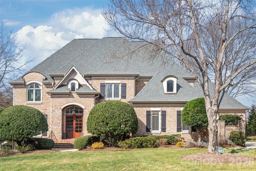 Live, entertain, and enjoy with ease in this custom built home in Ballantyne Country Club, featuring a four-car garage, full brick exterior, and thoughtfully updated interior and outdoor spaces. At the heart of the home is a fully renovated designer chef’s kitchen, featured in SouthPark Magazine. Ceiling-height cabinetry, quartzite countertops, and hidden organizational features create a clean, modern aesthetic while keeping everything beautifully tucked away. Nearby living and dining spaces flow seamlessly, highlighted by Shaker-style built-ins, a honed Carrera marble fireplace, and a custom black bar with rollout shelves and quartize countertops.

The main level offers a guest bedroom with a beautifully updated full bath, ideal for visitors or multigenerational living. Upstairs, the primary suite provides a true retreat, anchored by a spa-inspired bath renovation featured in Queen City Exclusive, along with custom closet shelving. Three additional bedrooms and a spacious bonus room complete the upper level, including another fully renovated bathroom. 

Experience luxury outdoor living with a stone paver patio, outdoor kitchen, and louvered pergola with motorized screens, ideal for hosting gatherings or enjoying quiet evenings at home. Peace-of-mind improvements include a newer roof with skylights (2023), first-floor furnace (2025), updated all electrical outlets throughout (2025), and more.