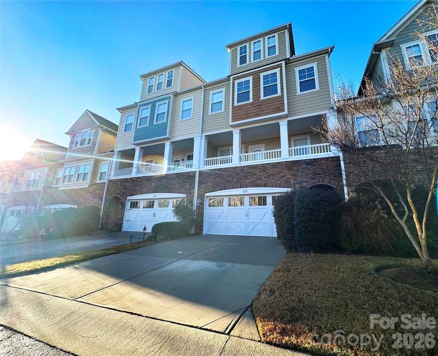 The ease of lock-and-leave living, without compromising on space! This luxury townhome offers more than 3,300 square feet, complete with the convenience of an elevator serving all four floors. The first floor features a two-car garage with EV charger, a spacious foyer, and a full bedroom suite, also ideal as a home office. It opens to a lower-level paver patio, a perfect spot for gardening or relaxing outdoors. The main living level is designed for entertaining, with a spacious kitchen featuring granite countertops, newer stainless steel appliances, a pantry, and a dining room with tray ceiling. A charming covered front porch adds to the appeal. The living room includes a fireplace and two sets of French doors leading to another outdoor space, a deck perfect for al fresco dining. There is also a pocket office with built-ins. Upstairs, you will find three additional bedrooms and two full baths, including the primary suite with a walk-in closet and a bath featuring a dual vanity, soaking tub, and separate shower. Laundry is conveniently located just outside the bedrooms. The fourth floor is the icing on the cake, a bonus space with a full bath, ideal as an additional bedroom suite, plus access to a lovely rooftop deck. Ideally located near Lake Wylie with nearby walking trails, and just up the hill from the Tega Cay Beach Club (membership required), this home offers easy access to recreation, dining, and more. Welcome home!