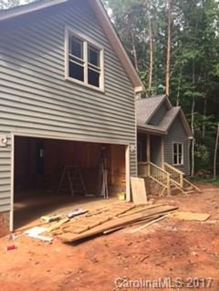Lovely new construction nestled in the woods, ranch style with hardwood floors, granite, lovely cabinetry, open and spacious, bonus/bedroom upstairs, overlooks a pond in the neighborhood, privacy plus.