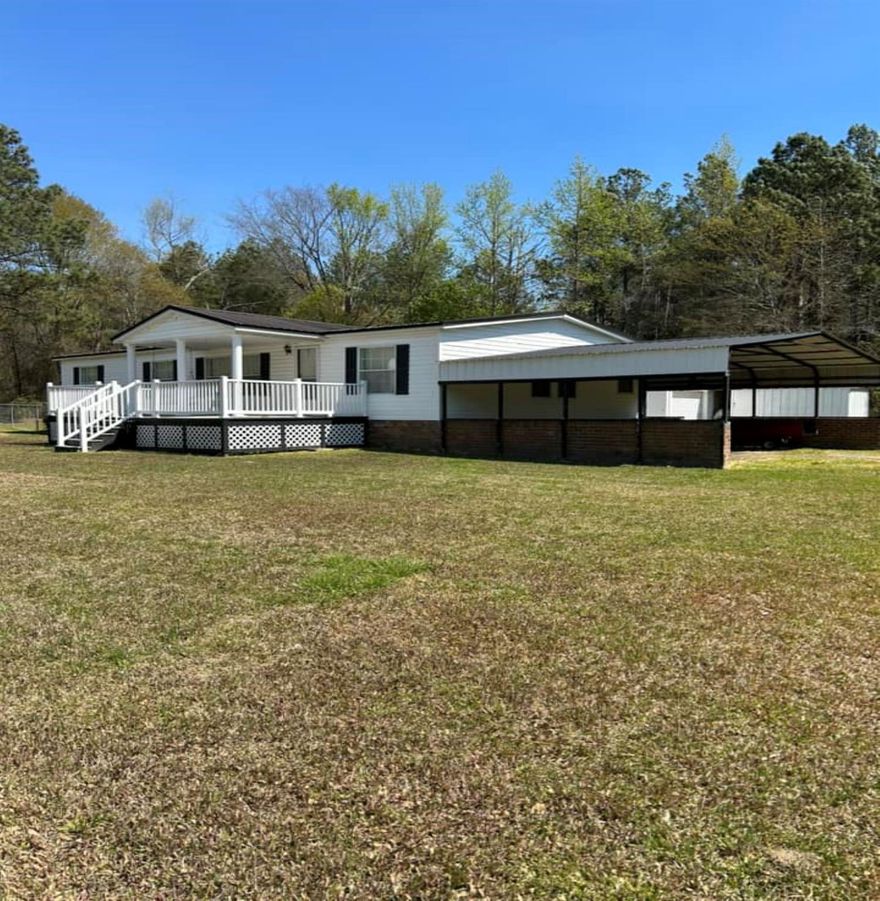 Turn-key ready! Save time and just pack your bags! The furniture and appliances will convey. This large, private lot and well-maintained home is all that you need! Relax on the spacious, covered, front porch and swing while overlooking the sunset across the beautiful lawn or have dinner on the private, covered back porch. The convenience of city water is available. There is plenty of natural lighting throughout the home. The primary bedroom features a grand ensuite and newly renovated bathroom with two vanities and a walk-in shower. There is another full guest bathroom and two more spacious bedrooms. The fireplace is perfect for relaxing or step outside to work in the private shop that has a roll-up door, electricity, access to be heated/cooled, excellent storage, shelving and a work bench. This is a handy person's dream! Building could also be a potential family/in-law suite. There are two additional shops for storage. Perfect for entertaining with a concrete patio and fenced in yard.