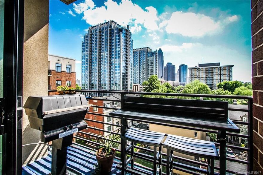 Impressive condo for under 200K in desirable Fourth Ward location.  Corner unit on Seventh Floor of a secure building with underground parking garage.  Great views from every window. Beautiful city skyline view.  It is 665 sq. ft., 2 BD, 1 BA with balcony, gas grill and gas range. Brand new Pergo wood flooring in living area and bedrooms. Enjoy gas log fireplace in living room.  Refrigerator and stackable washer/dryer stays.  Building has pool and rooftop terrace with kitchen.