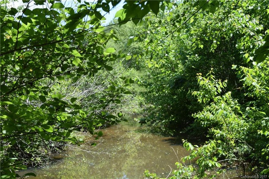 This 54.43 acres is comprised of three parcels of land. There is approximately 925 feet of road frontage on Nanneytown Road. This 54 acres is mostly wooded but does have an old dirt road that goes to the back of the property which has cleared land around Cathys Creek. The creek flows into a flood protector lake just past the property line. The fields are currently grown up and hard to walk. There appears to be a few fence lines on the properties and possibly some abandoned structures.